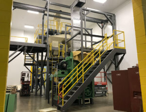 carbon steel stairs featuring OSHA-compliant yellow handrails and a steel-it finish
