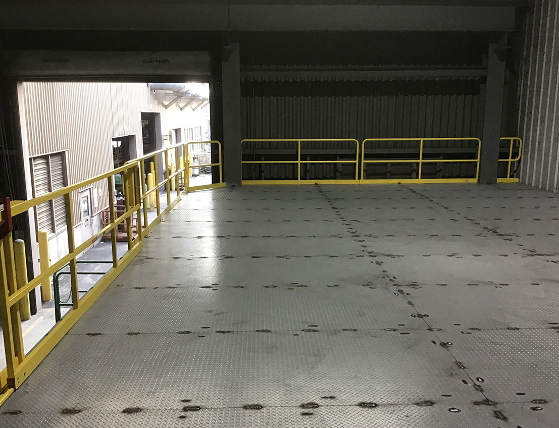 Large platform installation in progress with diamond plate stainless steel flooring and yellow osha compliant rails