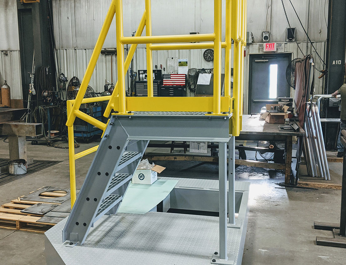 diamond plate bases and osha-compliant stairs forming a stainless steel, painted platform