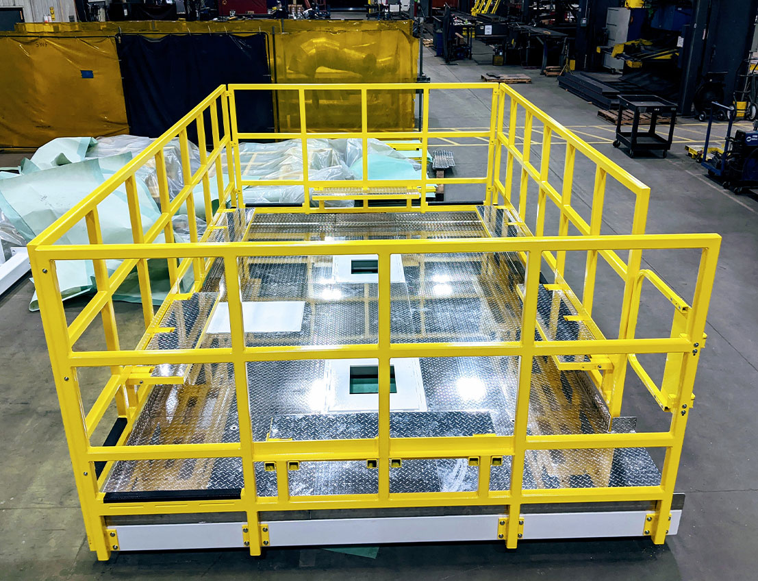 stainless steel platform with bright yellow osha compliant railings and diamond plate flooring