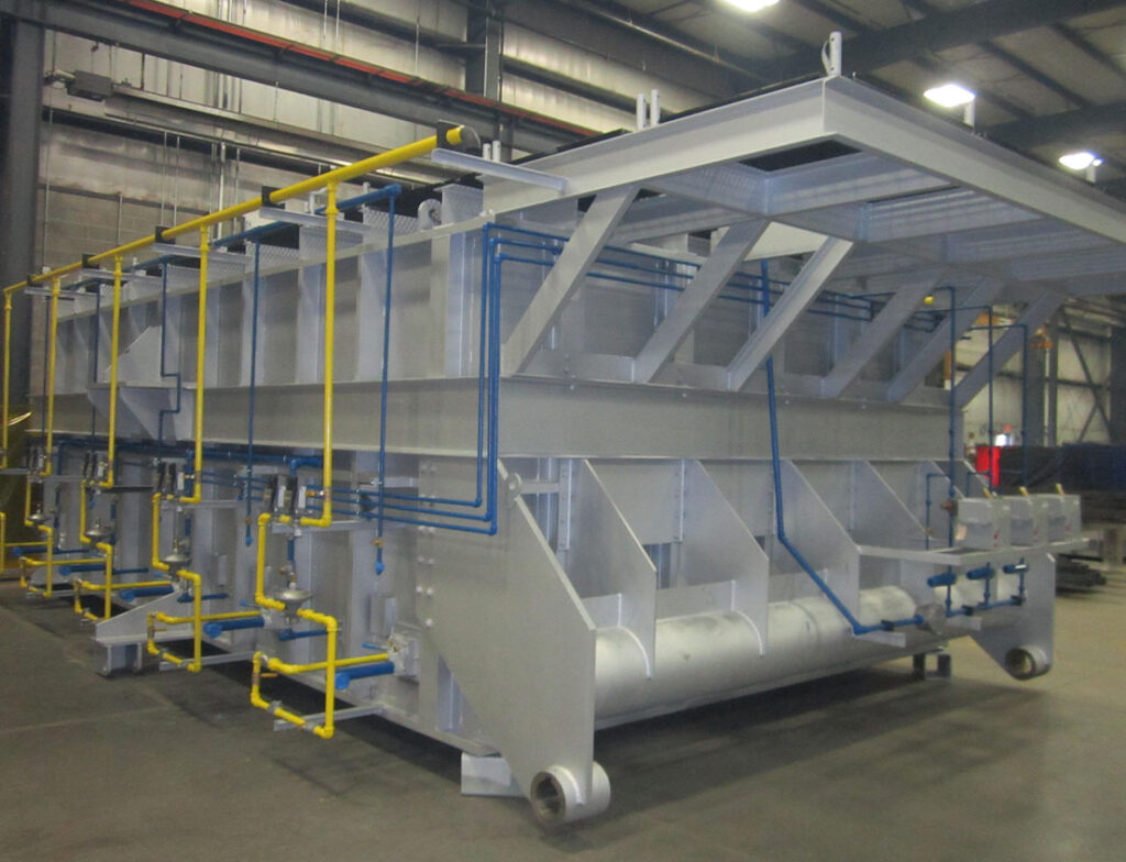 Industrial Furnace under construction shown with yellow piping and silver paint