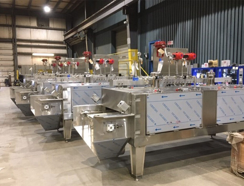 Stainless Cryogenic Equipment flash freezers in bright silver with white non-scratch covers on the doors and red valves
