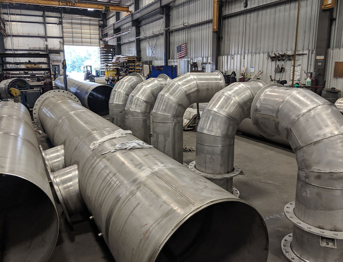 a row of fabricated stainless steel piping and piping valves