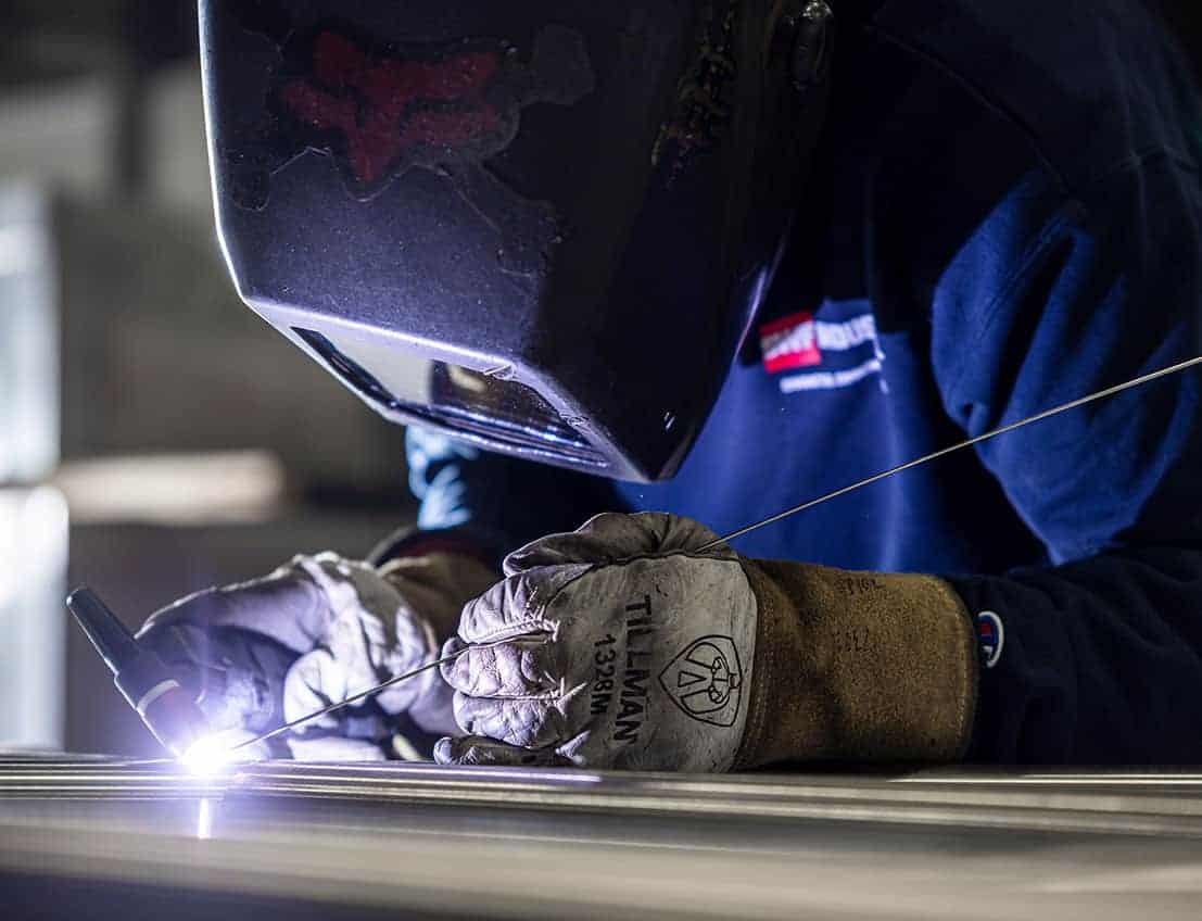 Close up action shot of a welder from SWF Industrial fabricating a railing