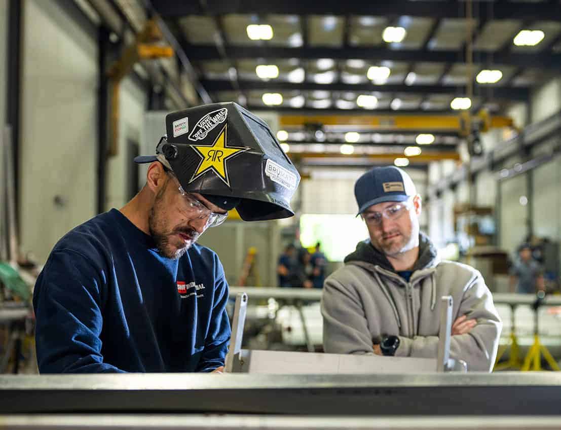 CEO brandon stanchock observes a welder at SWF industrial