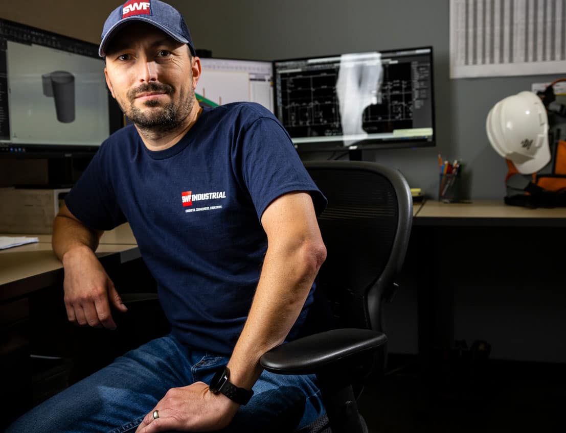 Portrait image of a 3D modeling and design professional from SWF Industrial sitting at his desk