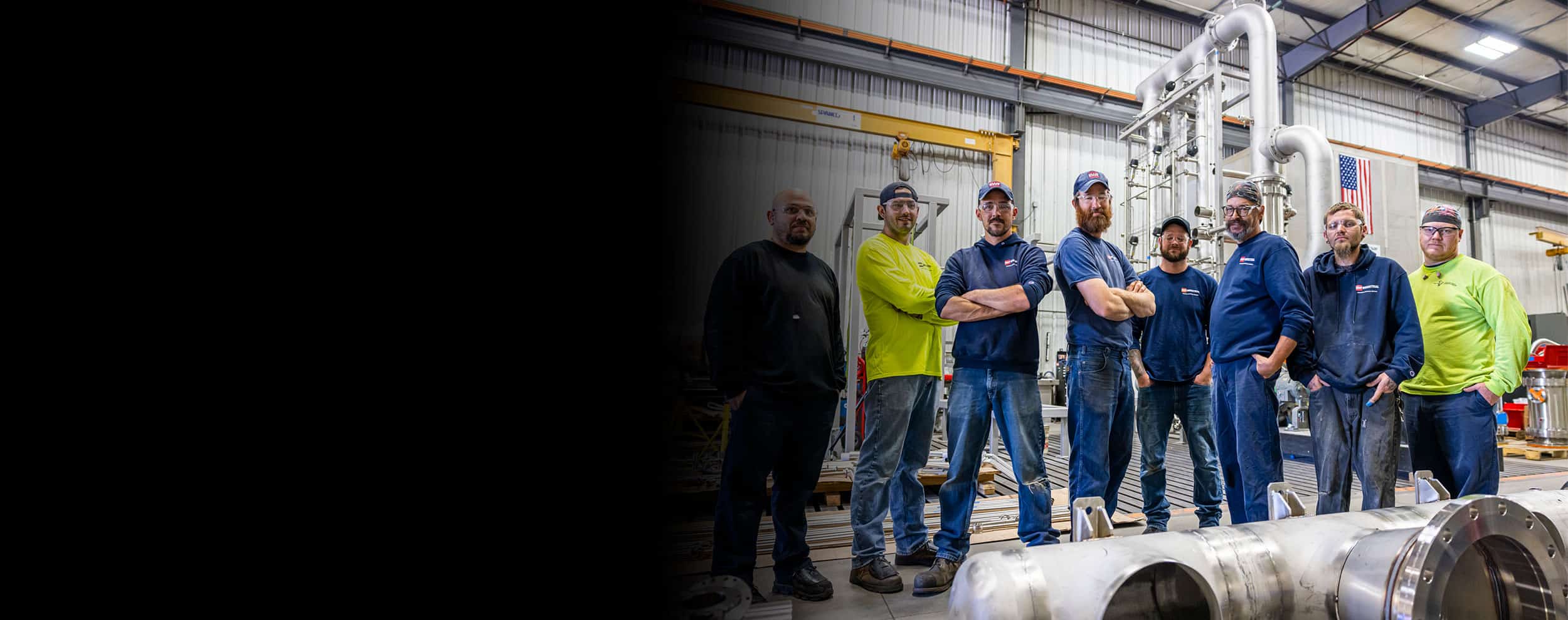 SWF Industrial crew standing in the warehouse in blue and bright green yellow shirts