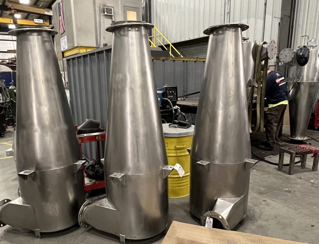 stainless steel cyclones, featuring a uniform 2B finish and food-grade surfaces sitting on the fabrication floor waiting for final assembly
