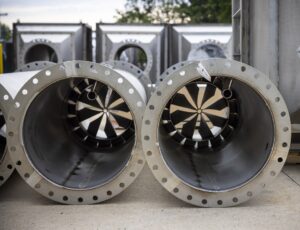 stainless steel mix tubes with precision fins and bolt holds for air handling units pictured while staging for shipping