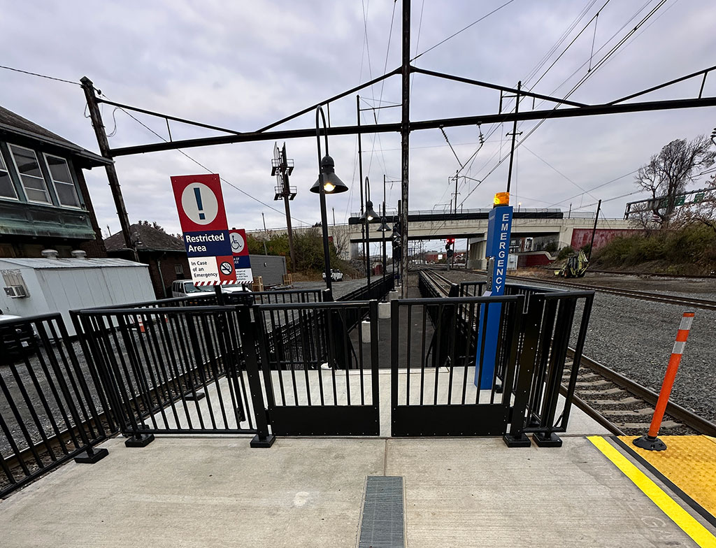 Safety gates and handrails shown at the end of the loading area.