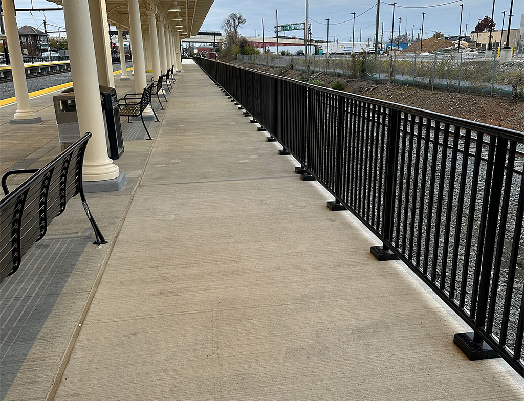 Cast iron bases shown in place under columns with the black handrail visible in the image.